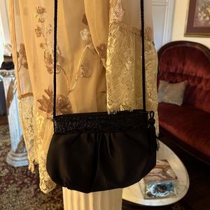 Small black bag satiny feel sequined top. Great for evening wear.
